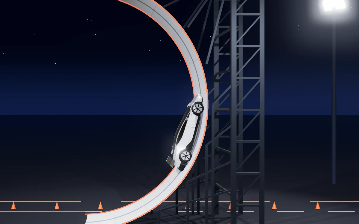 The roadster driving up the vertical face of a tall curved white ramp at night.