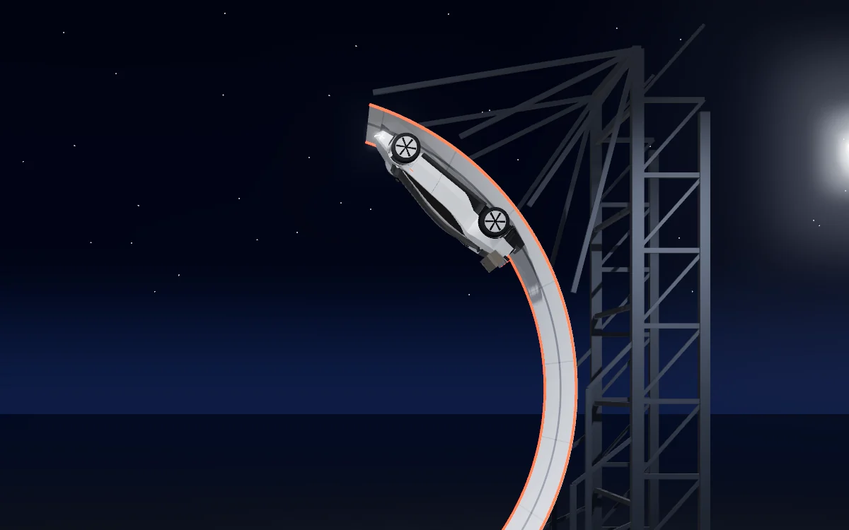 The roadster upside down near the top of the curved ramp, beside a steel truss.